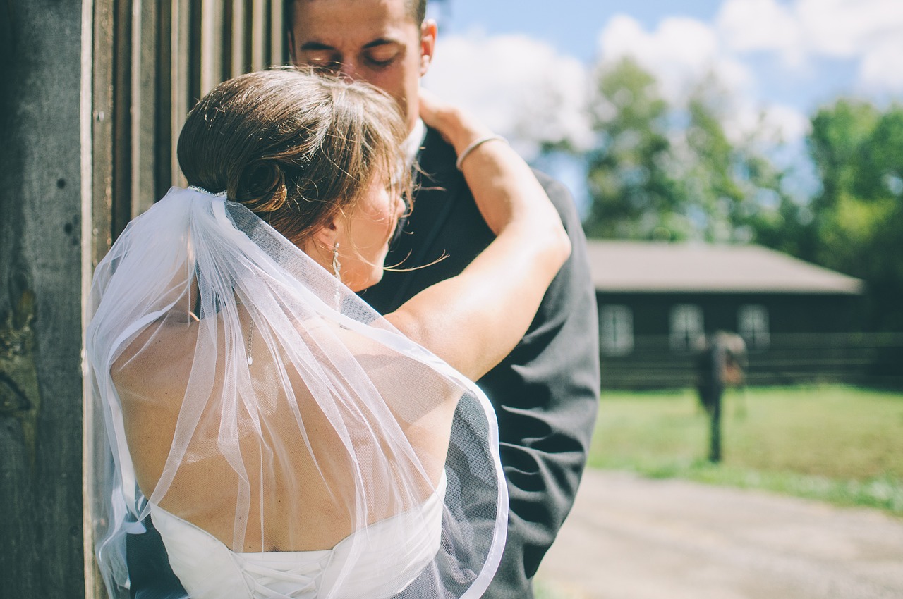 Newlyweds embracing at golden hour