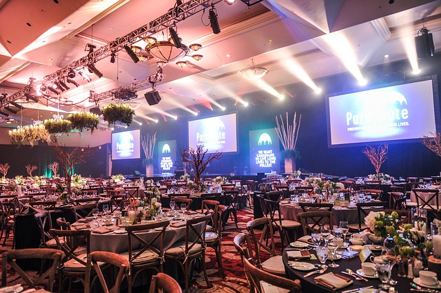 Tables around a stage at a gala
