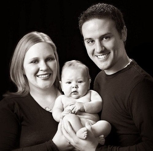 New parents with their newborn in the studio
